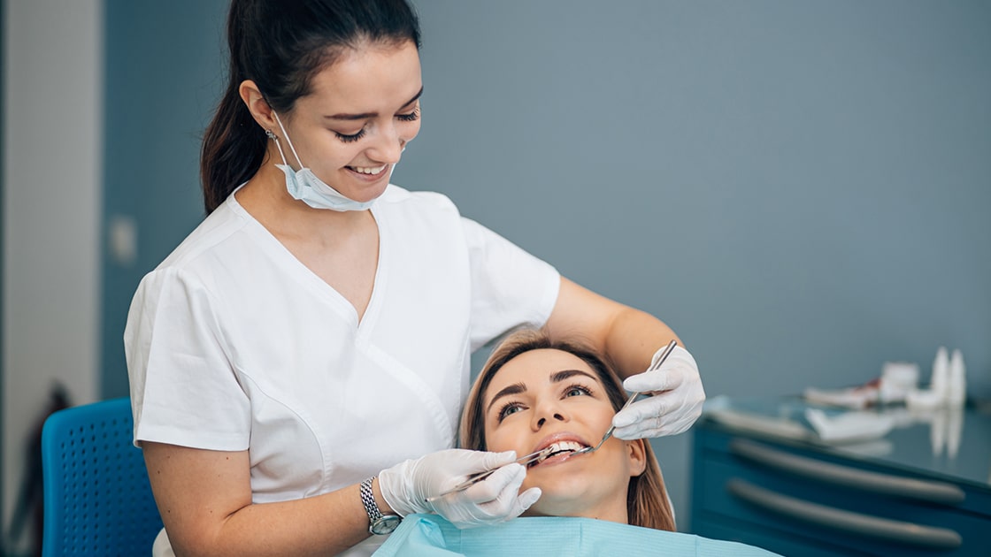 Assistant performing dental exam photo