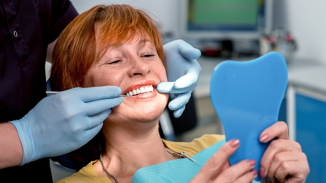 Smiling Patient Looking in Mirror