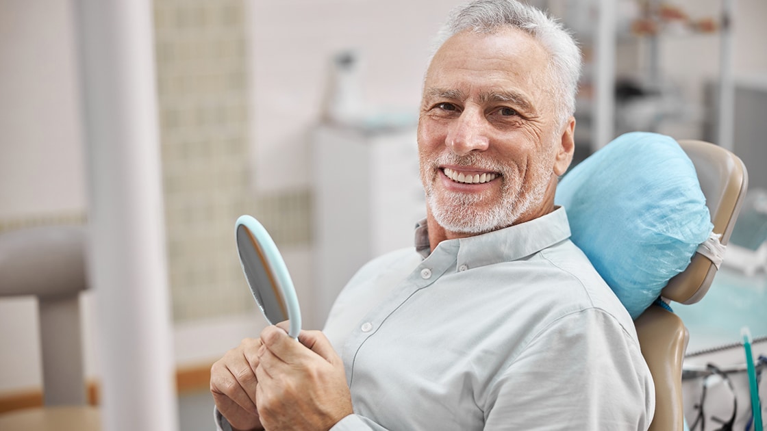Smiling mature man in dental chair