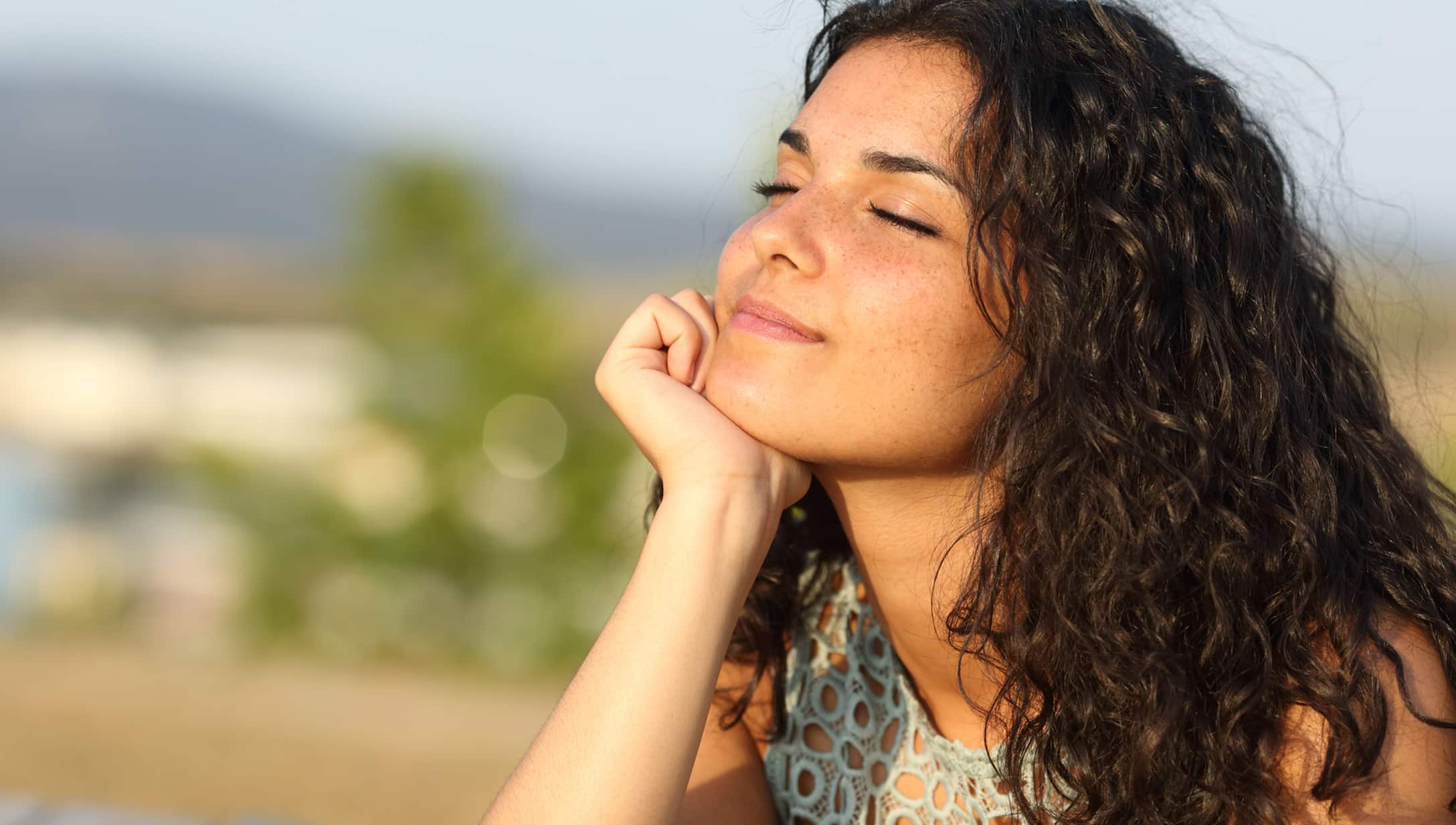 Smiling woman with sun on her face